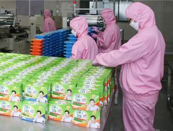 身着洁净服（无尘服）的食品加工生产线工人